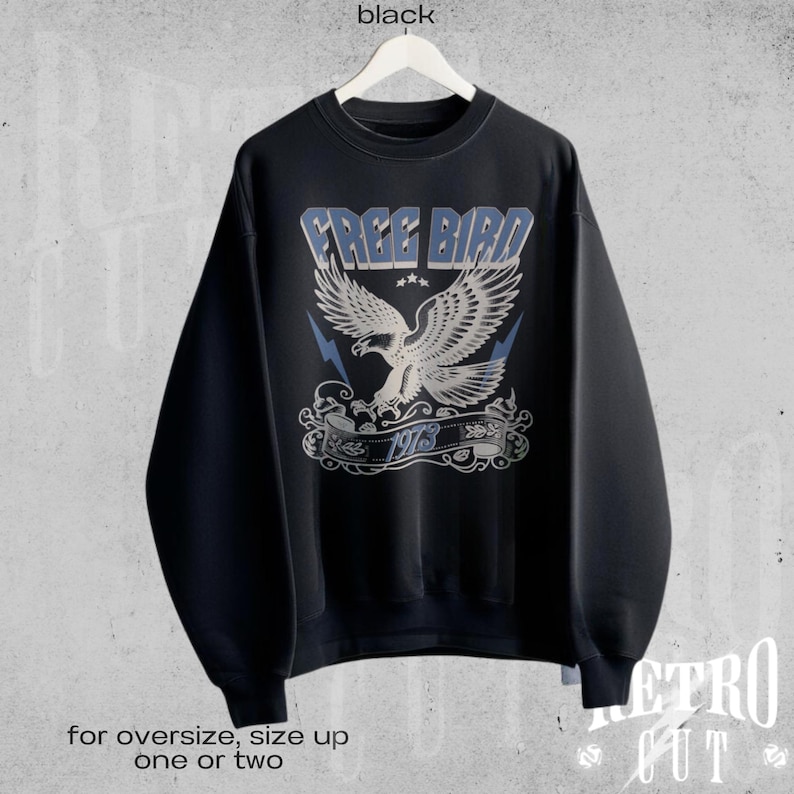 May include: Black sweatshirt with a vintage-style graphic of an eagle in flight with the text "FREE BIRD 1973".