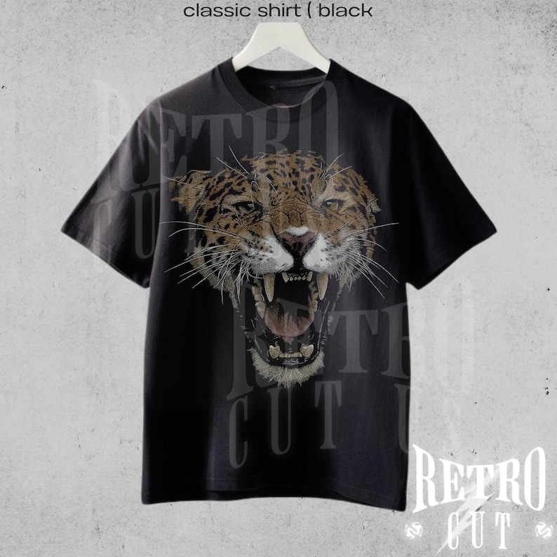 May include: Black t-shirt featuring a graphic of a roaring jaguar's head. The text "Retro Cut" is printed on the shirt.