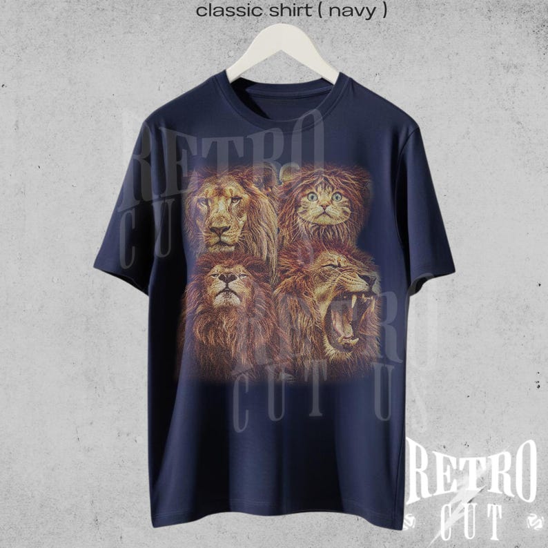 May include: A navy blue t-shirt with a graphic print of four lion faces, including a cat face. The text "Retro Cut" is printed on the shirt.
