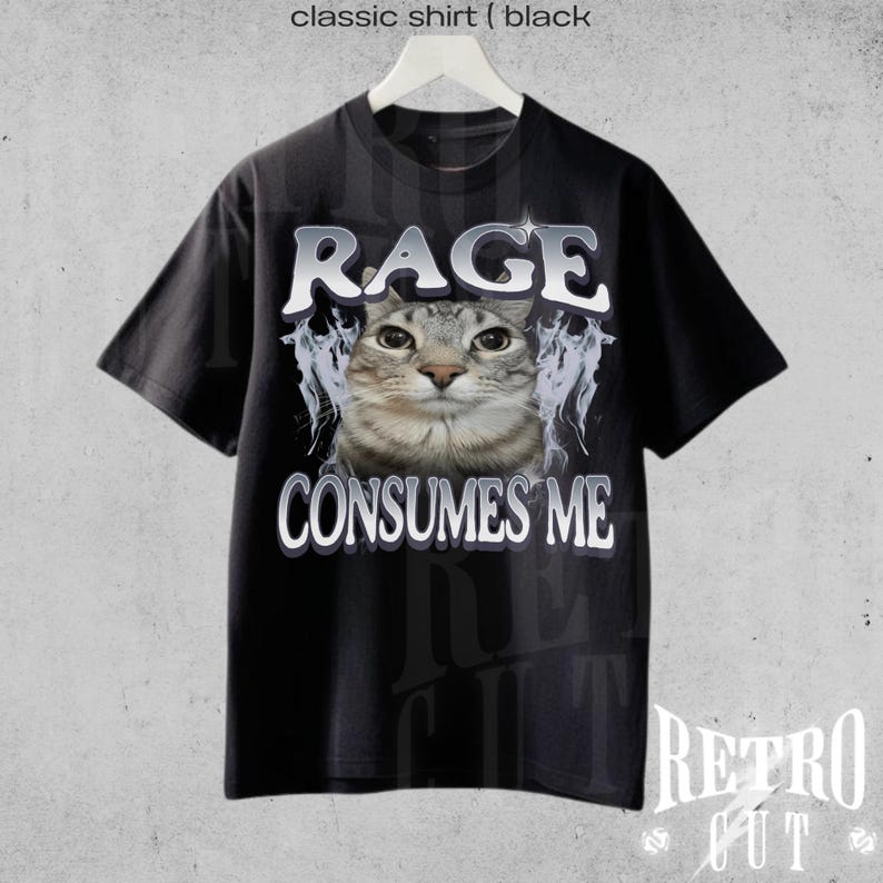 Puede incluir: Camiseta negra con un gr&aacute;fico de un gato y el texto "Rage Consumes Me".
