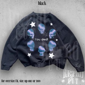 May include: Black sweatshirt with a graphic design featuring blue human head shapes, white stars, and the text "You died!". The text "black" is at the top, and "for oversize fit, size up one or two" is at the bottom.