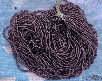 Antique glass beads: XL hank of tiny seed beads in transparent dark purple, sizes  14/0 - 18/0.