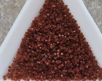 Size 16/0 vintage micro hex cut seed beads in color lined nutmeg brown. Antique European glass tube or cylinder beads for fine detail.