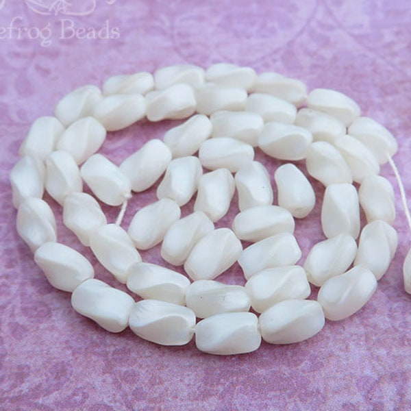 1940's vintage Czech twisted oval beads in white satin. 50 pressed glass 4x6 mm oval tubes with semi translucent moonstone effect.