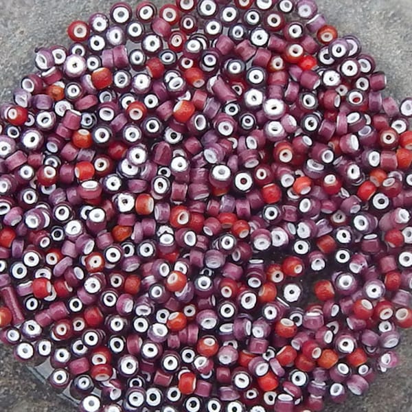 Late 1800's vintage or antique Venetian white heart glass seed beads. Size 9/0 burgundy plum mix. 10 grams.