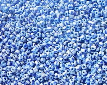 Size 11/0 or 12/0 vintage Venetian seed beads in opaque white blue stripes. 10 grams of collectible old Italian glass beads.