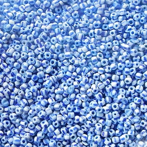 Size 11/0 or 12/0 vintage Venetian seed beads in opaque white blue stripes. 10 grams of collectible old Italian glass beads.