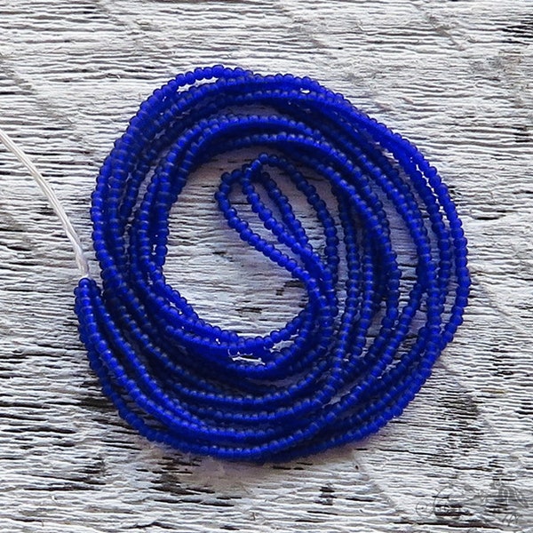 Tiny hank of size 16/0 antique micro seed beads in matte cobalt blue. Vintage European glass microbeads for fine beadwork and purse repair.