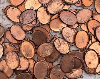 Vintage cabochon settings for 13x18 mm oval stones. 6 piece lot of copper coated steel bezel frames with 2 rings and closed flat back.