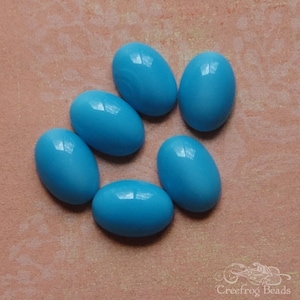 Lot of 6 vintage 1960&#39;s West German glass moonstone cabochons in opaque sky blue. Vibrant blue 10x14 mm oval cabs w/ unfoiled flat backs.