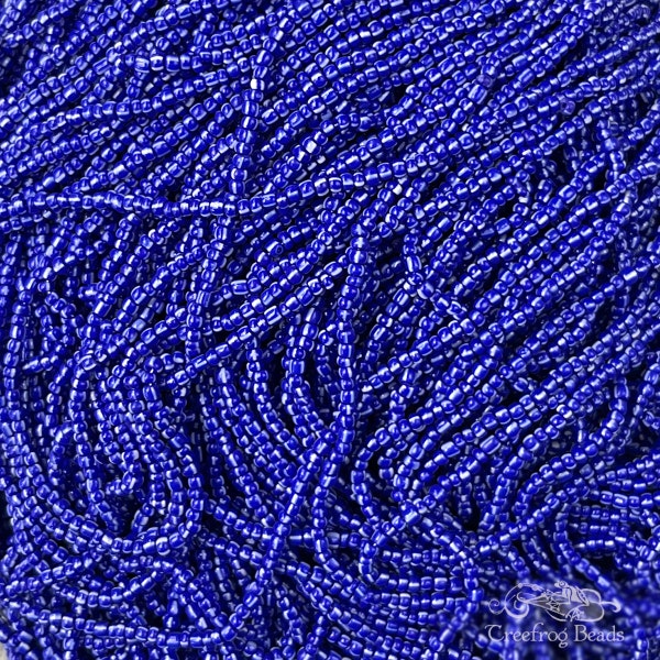 1 hank of 90's vintage Czech glass seed beads in size 10/0 opaque navy blue with white stripes. 48 gram hank of old stock striped rocailles.
