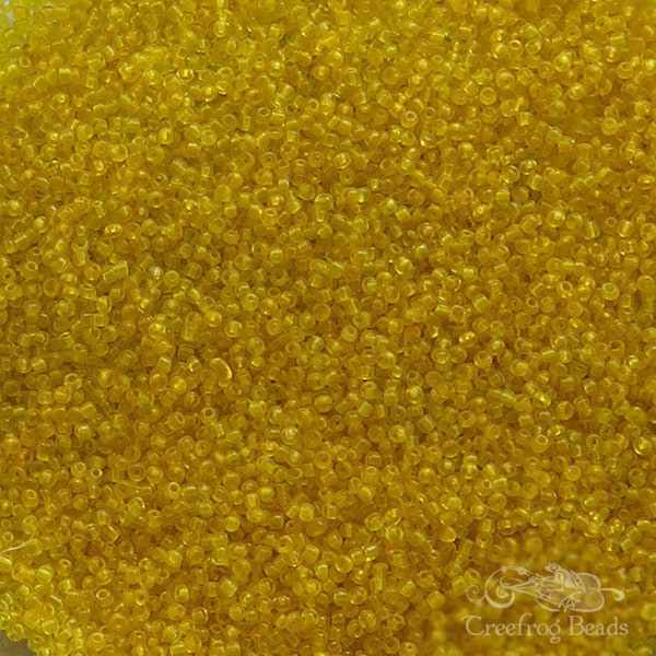 Size 16/0 vintage micro seed beads in transparent golden honey yellow. Tiny rare antique glass beads, for purse repair and doll making.