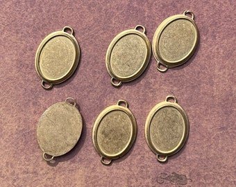 Vintage cabochon settings for 13x18 mm flat back oval stones. 6 piece lot of old stock cameo bezel frames with closed backs and 2 loops.