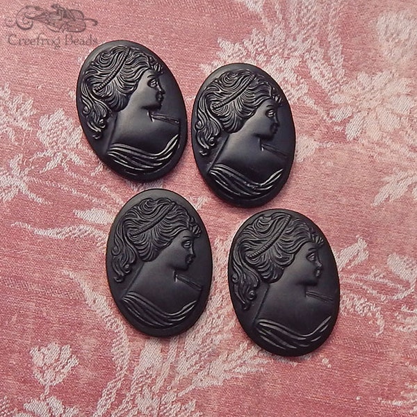 1960's vintage glass cameos in opaque black. 25x18 mm lady cabochon with raised profile of a woman with a ponytail. Choose 2 pc or 4 pc.