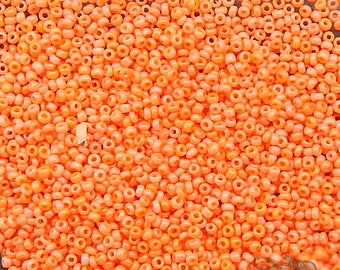 Size 18/0 antique glass micro seed beads in opaque orange sunset. Tiny vintage microbeads for detailed beadwork, doll art, or purse repair.
