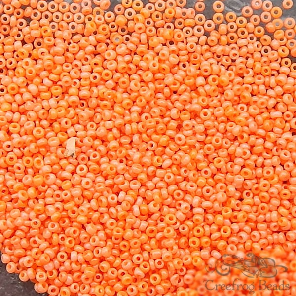 Size 18/0 antique glass micro seed beads in opaque orange sunset. Tiny vintage microbeads for detailed beadwork, doll art, or purse repair.