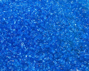 Size 16/0 vintage micro seed beads in transparent capri blue. Tiny rare antique Italian glass tube shaped cylinder beads for fine detail.