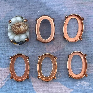13x18 mm raw brass settings for oval stones. 6 piece lot of 4 prong open back cameo bezel frames in red brass with gingerbread patina.