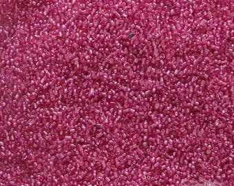 Size 22/0 antique microbeads in transparent wild rose pink. Vintage glass micro seed beads for miniature work, doll arts and purse repair.