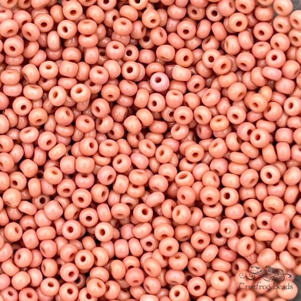 Old Czech glass seed beads, size 8/0 dark Cheyenne pink. 1990's vintage rocailles in opaque peachy salmon pink - sold by the gram or ounce.