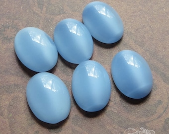 Vintage glass faux moonstone cabochons in light sapphire blue. 10x14 mm oval cabs in pale blue. 6 flat backed stones with unfoiled backs.