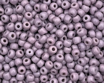 Size 5/0 antique Italian glass seed beads in opaque pale purple. 10 grams late 1800's vintage Venetian pony beads in light lavender orchid.