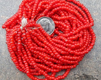 Antique Venetian white heart seed beads in size 8/0 cherry red. 10 grams of old Italian glass trade beads in red w/ white core.