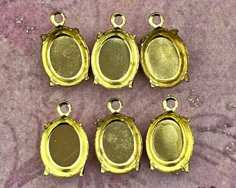 10x8 mm raw brass cabochon settings with 4 prongs and a single top loop. 12 pc lot of  vintage brass findings for 8x10 oval stones.