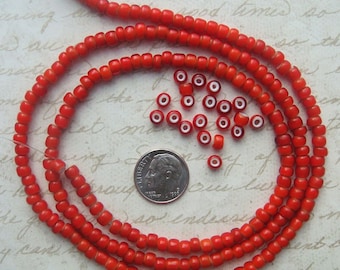 1930&#39;s Vintage Italian whiteheart glass beads in cherry red. 30&quot; strand of collectible Venetian trade beads. Red glass with white core.