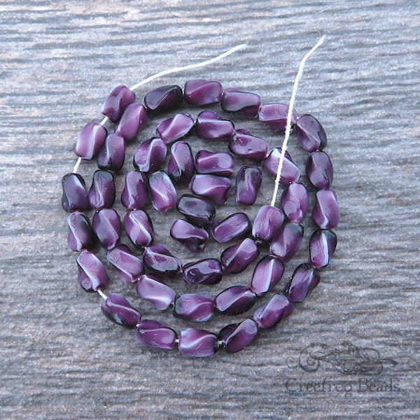 50 vintage pressed glass beads in variegated purple and white satin. Strand of 4x6 mm twisted oval rice shaped beads, made in Czechoslovakia