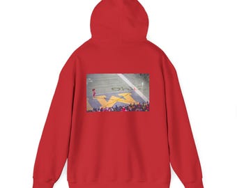 May include: A red hooded sweatshirt featuring a graphic on the back. The graphic depicts a football field with a large yellow "M" and a player. The sweatshirt is a solid red color.