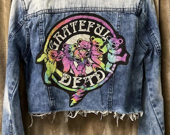 Ladies' Grateful Dead denim jacket. Ladies' Amethyst Jeans, size Medium with Grateful Dead tee attached to the back. Colorful tee, one only