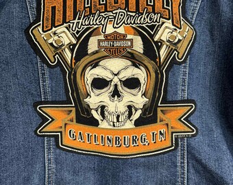 May include: A black and orange embroidered patch with the text "Hillbilly Harley-Davidson" and a skull wearing a helmet. The patch also includes the text "Gatlinburg, TN".