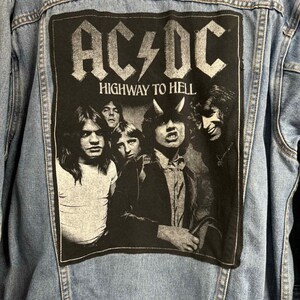 May include: Light blue denim jacket with a large black patch featuring the band AC/DC and the words "HIGHWAY TO HELL." The patch displays a black and white image of the band members.