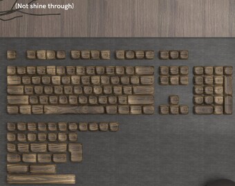 May include: A set of 134 wooden keycaps in a brown color with a top-print design. The keycaps are suitable for 61, 68, 84, 87, 96, 98, 100, 104, and 108 mechanical keyboards. The keycaps are labeled with the letters of the alphabet, numbers, and symbols.