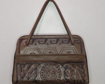 Vintage 1960s hand-tooled leather handbag. Aztec calender and bull fighter motif.
