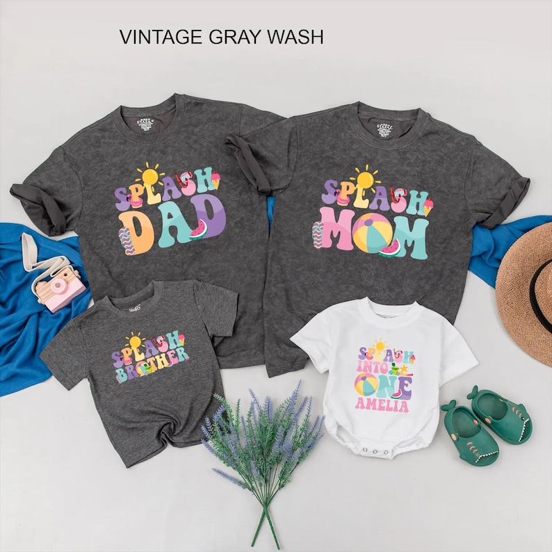 May include: A collection of family summer outfits, including grey t-shirts with "Splash Dad", "Splash Mom", and "Splash Brother" printed on them, and a white baby onesie with "Splash Into One". The image also shows a straw hat and green shoes.