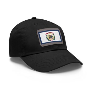 May include: Black baseball cap featuring a rectangular patch with the West Virginia state flag. The flag includes a white field, a blue border, and the state seal. The cap has a curved brim and a button on top.