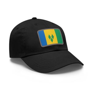 May include: Black baseball cap with a rectangular patch featuring the flag of Saint Vincent and the Grenadines. The flag design includes blue, yellow, green, and diamond shapes. The cap has a curved brim and a button on top.