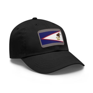 May include: Black baseball cap featuring a rectangular patch with the American Samoa flag. The flag design includes blue, white, and red stripes, with an eagle emblem. The cap has a curved brim and a button on top.