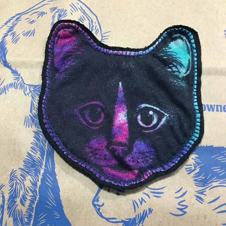 Sewn on black backing with navy thread. Plain cat face patch CAT face patch Black cat graphic on purplepinkteal fabric