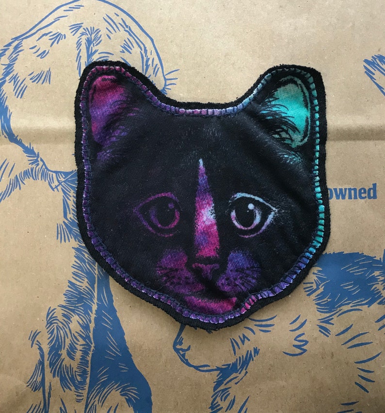 Sewn on black backing with navy thread. Plain cat face patch CAT face patch Black cat graphic on purplepinkteal fabric