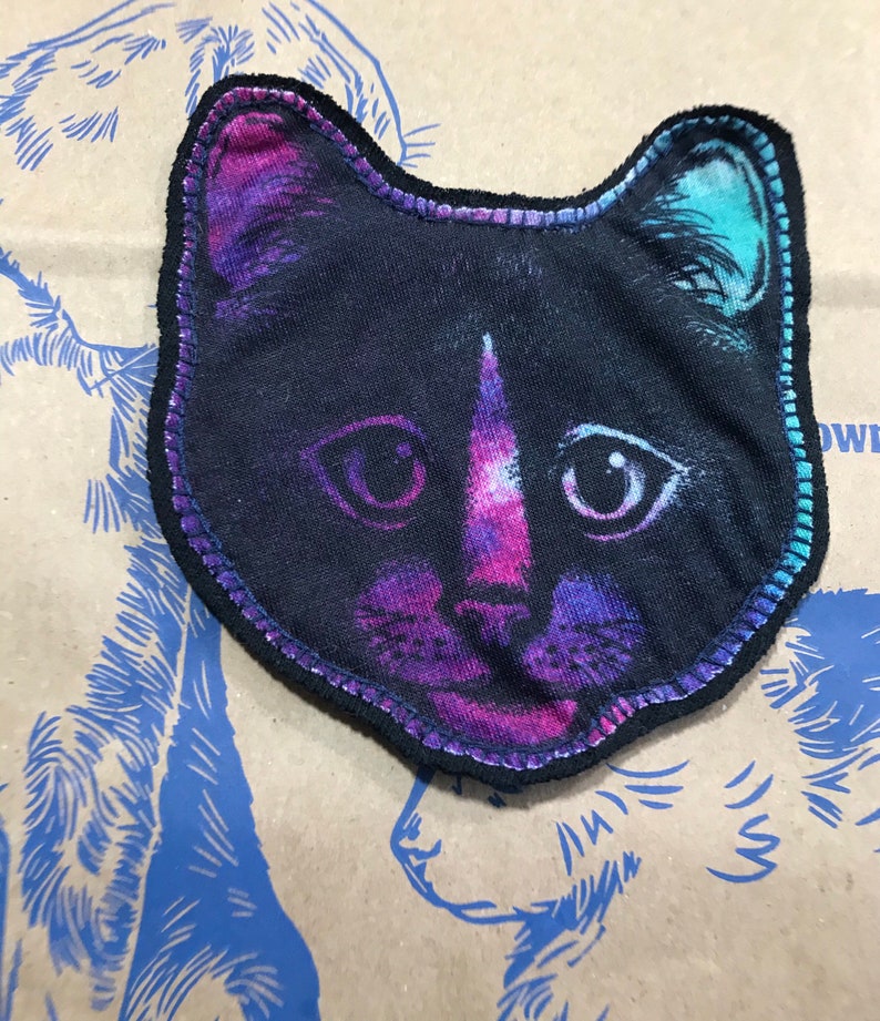 Sewn on black backing with navy thread. Plain cat face patch CAT face patch Black cat graphic on purplepinkteal fabric