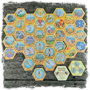 May include: A Honey Hive Lenormand deck of cards with 36 hexagonal cards featuring illustrations of bees, honeycombs, flowers, and other nature-themed imagery. The cards are laid out in a honeycomb pattern on a wooden surface. The box for the deck is also visible in the image.
