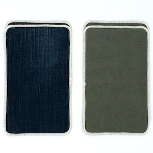 May include: Two fabric swatches with white stitching around the edges. The swatch on the left is dark blue and the swatch on the right is dark green.