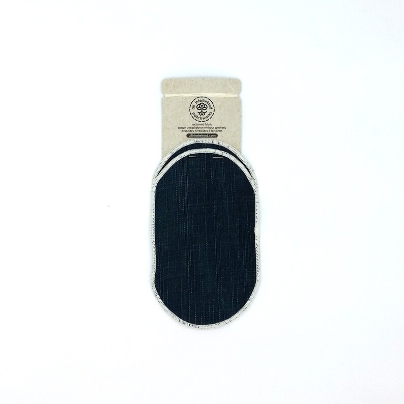 May include: Two oval-shaped denim patches with white stitching around the edges, attached to a cardboard backing. The cardboard has a logo and text that reads "oliver+winnie". The patches are dark blue.