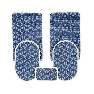 May include: A set of five blue bath mats with a white geometric pattern. The mats are in different sizes and shapes, including a rectangle, two ovals, and two squares.