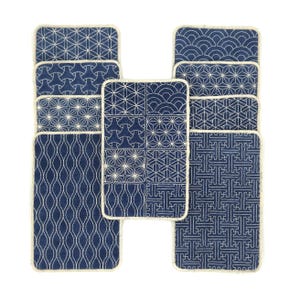 May include: Set of ten blue and white fabric coasters with different geometric patterns. The coasters have a white border and are made of a soft, textured fabric.