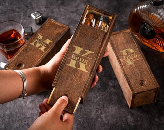 May include: Three wooden boxes with personalized names, "Merlin", "Kevin", and "Peter", engraved on the front. Each box has a sliding lid and is made of dark brown wood.