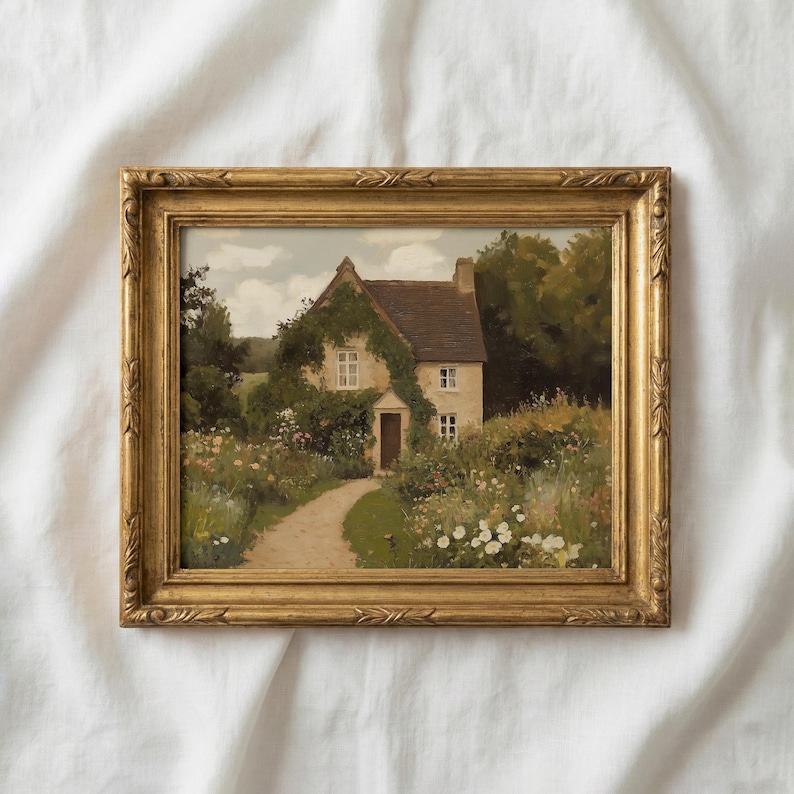 May include: A framed painting of a cottage with a path leading to the front door. The cottage is surrounded by a lush garden with colorful flowers and greenery. The frame is gold with ornate detailing.